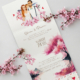 Faire-part Japon Bohème chic original avec vos portraits dessinés d’après vos photos. Thème Japon. Couleurs rose, rouge et blanc. Avec fleurs de cerisier sakura et mont fuji. Invitation personnalisable pour mariage, Baptême, anniversaire, bar mitzvah